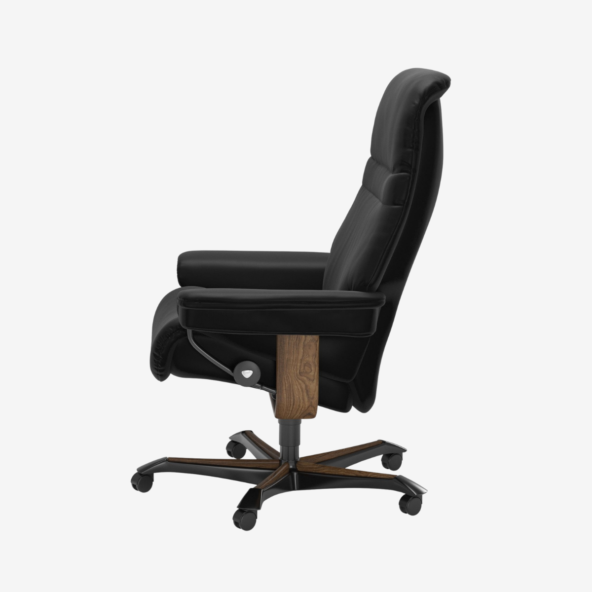 A black leather high-back office chair with a footrest, featuring a dark wood central column and a five-star black metal base with casters, shown from a side profile on a light gray background.