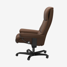 A brown leather high-back office chair with a black five-star wheeled base, shown from a side profile view against a plain white background.