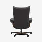 A high-back office chair upholstered in dark gray fabric, featuring brown wood-look metal supports and a black five-star wheeled base, shown from the rear on a light gray background.